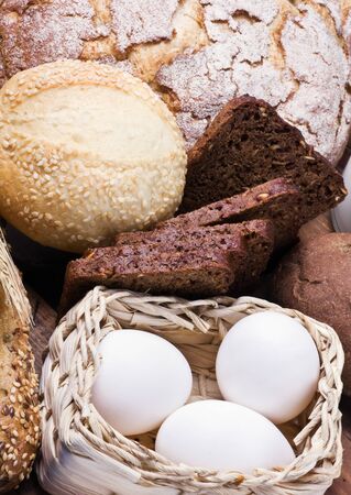 assortment of fresh baked bread and the ingredients needed to prepareの写真素材