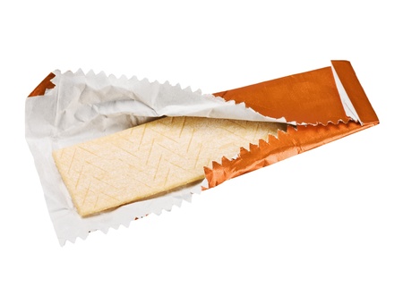 orange chewing gum is on the white background with paper の写真素材