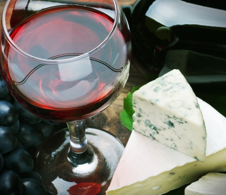 glass of red wine and grapes are ripe. Focus on a glass of wineの写真素材