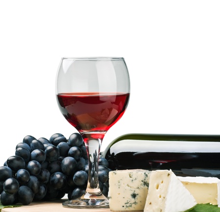glass of red wine with grapes isolated on white backgroundの写真素材