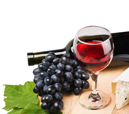 glass of red wine with grapes isolated on white background の写真素材