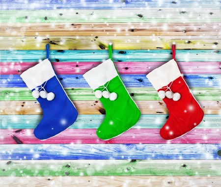 Christmas socks hung on a wooden fence colorの写真素材
