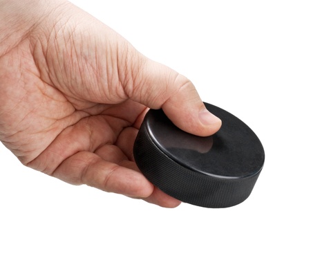 hockey puck in his hand isolated on white backgroundの写真素材
