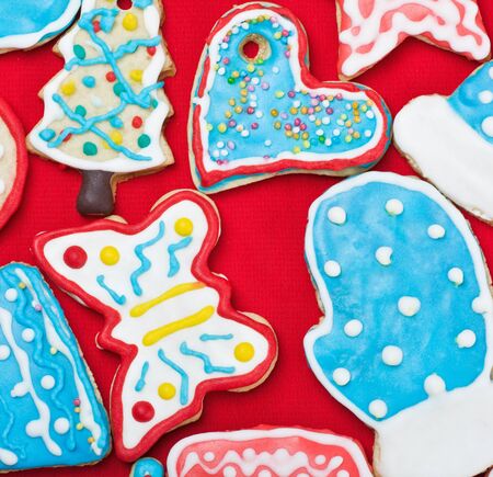 Christmas gingerbread cookies on the table covered with a red cloth の写真素材