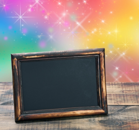 empty blackboard with wooden frame on a colored backgroundの写真素材