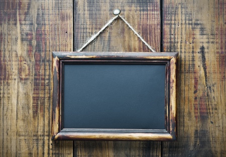 Blackboard on wooden background with space for text の写真素材