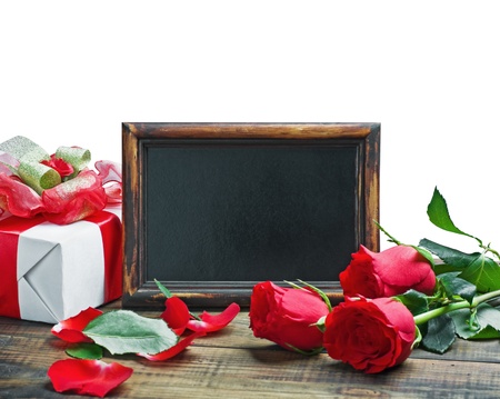 Red roses and gift for Valentine's Day or a birthday on a white backgroundの写真素材