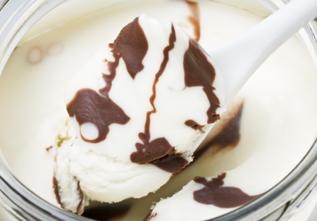 glass jar with chocolate spread backgroundの写真素材