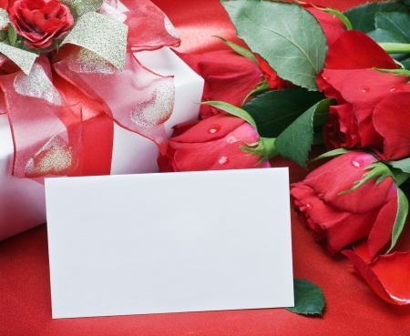 red roses and white card with a place for a congratulatory text の写真素材