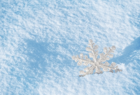 brilliant white snowflake on a blue snowの写真素材