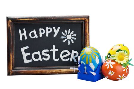 Easter egg and Easter greetings on a blackboard isolated on white backgroundの写真素材