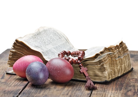 Easter egg and a rosary on an open Bibleの写真素材