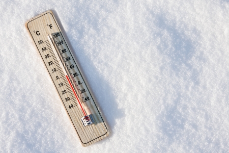 wooden thermometer in the snow with zero temperatureの写真素材