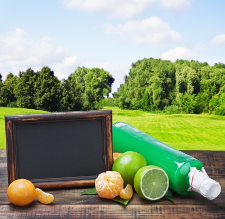bottle with the juice of citrus and lime on a background of natureの写真素材