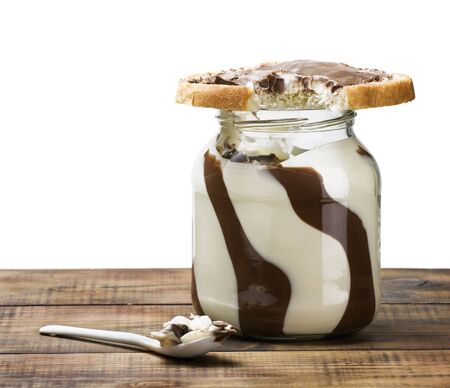 sandwich and a pot of chocolate spread on a wooden tableの写真素材
