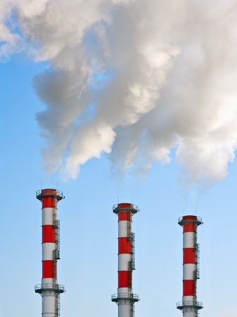 Smoking chimneys polluting the environment of the planet earthの写真素材