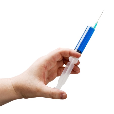 syringe in hand isolated on white backgroundの写真素材
