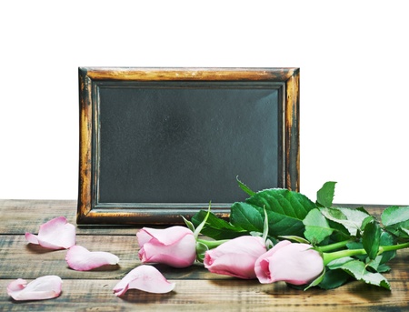 black board and pink roses on a white backgroundの写真素材