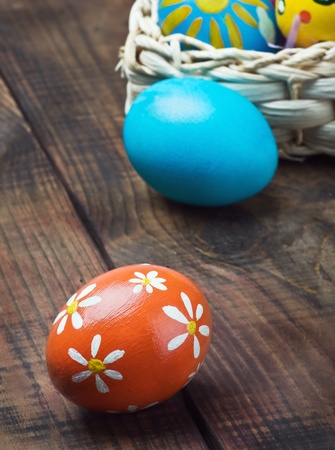 Painted Easter eggs in a basket on the tableの写真素材