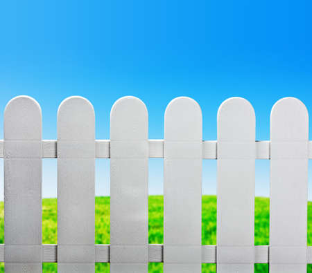 garden fence and green lawn behind the houseの写真素材