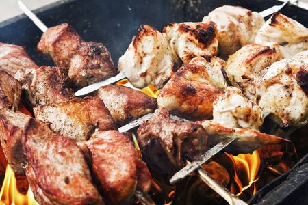 juicy slices of pork and chicken cooked over a fire. kebab.の写真素材