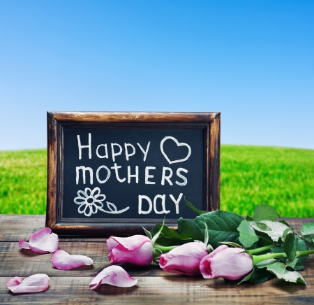 pink roses and congratulations on Mother's Day on the background fieldの写真素材