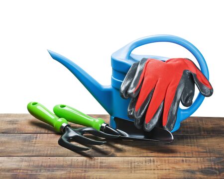garden tools lying on a wooden table on a background whiteの写真素材