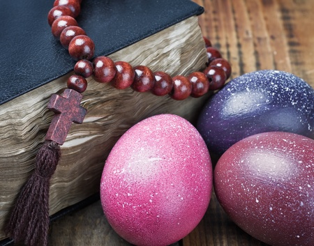 decorated with painted Easter eggs and an bible wooden tableの写真素材