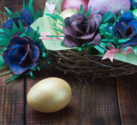 Colorful easter eggs and rose from the egg packagingの写真素材