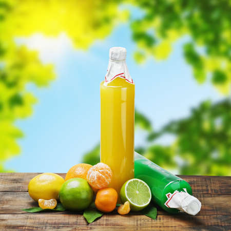 citrus juice bottle in the sun and leavesの写真素材