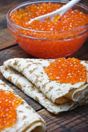 pancakes with red caviar on the tableの写真素材
