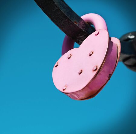 pink wedding metal lock on a background of skyの写真素材
