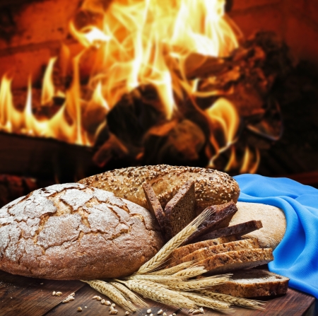 assortment of freshly baked bread and organic products on wooden tableの写真素材