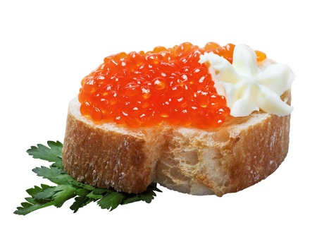 red caviar on slices of baguette isolated on a white backgroundの写真素材