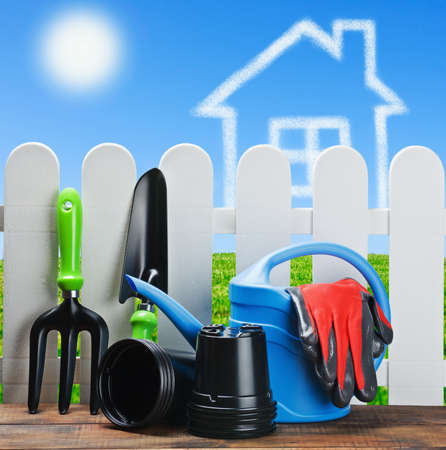 gardening tools on a background of clouds houseの写真素材