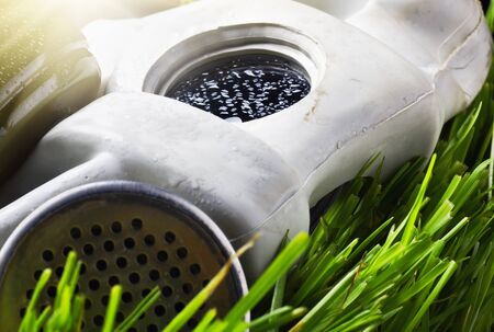 old gas mask on the grassの写真素材