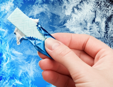 chewing gum in his hand against the frosty backgroundの写真素材