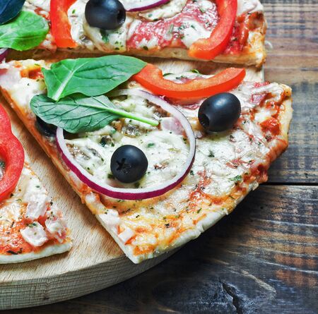 slices pizza with salami, olives and cheeseの写真素材