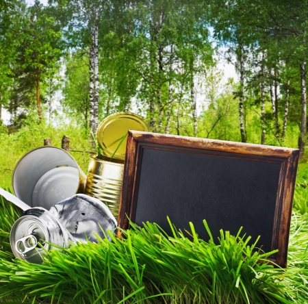 garbage cans of canned and blackboard on a background of forestの写真素材