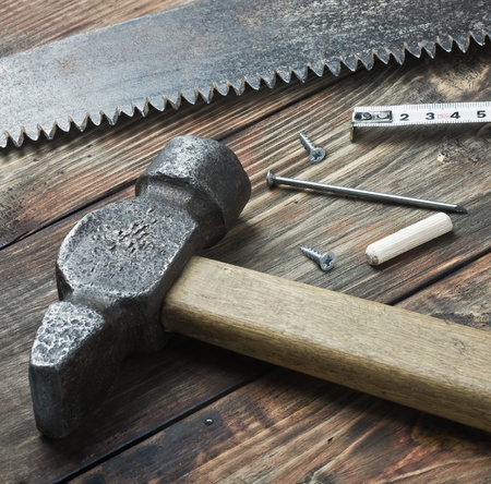 old tools for repairing lie on a wooden tableの写真素材