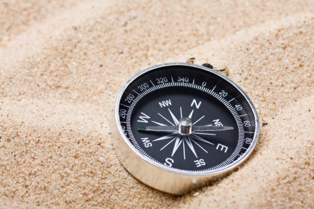 Tourist compass on the hot sandの写真素材