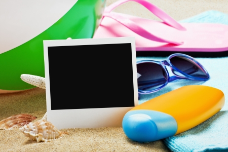 photoframe and beach gear on the sea sandの写真素材