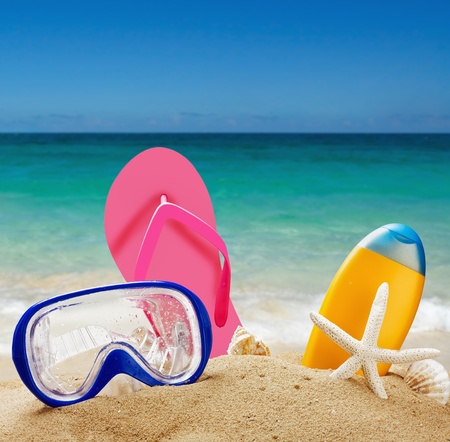 beach accessories in the sand against the sea landscapeの写真素材