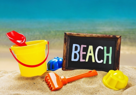 colorful toys for childrens sandboxes against the sea and the beachの写真素材