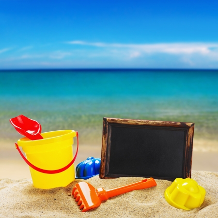 colorful toys for childrens sandboxes against the sea and the beachの写真素材