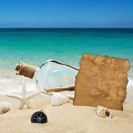 bottle with a note on the background of the sea beachの写真素材