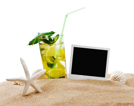 Mojito cocktail on the sandy beach with blurred sea in the backgroundの写真素材