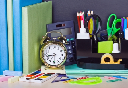 alarm clocks and school supplies on the school deskの写真素材