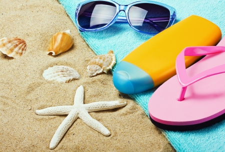 beach gear lie on the sand with shellsの写真素材