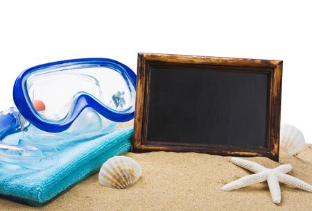 blackboard on the sand and other things for the beach isolated on white backgroundの写真素材
